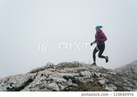 Trail Runner in Misty Mountain Landscape Trail Runner in Misty Mountain Landscape 128680956