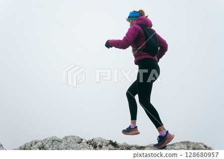 Trail Runner in Misty Mountain Landscape 128680957