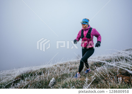 Trail Runner in Misty Mountain Landscape 128680958