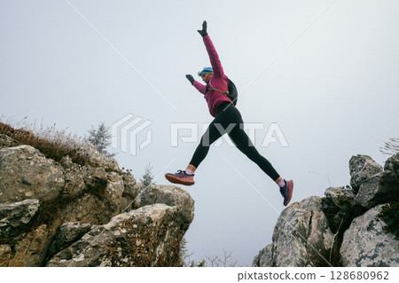 Trail Runner in Misty Mountain Landscape 128680962
