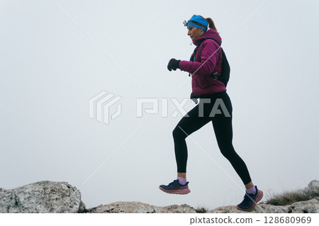 Trail Runner in Misty Mountain Landscape 128680969