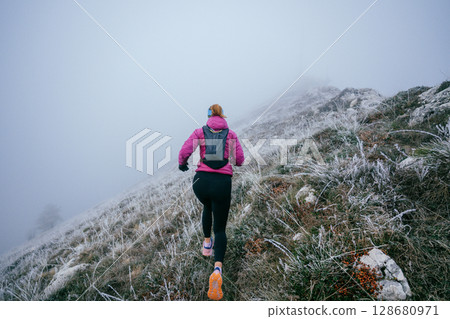 Trail Runner in Misty Mountain Landscape 128680971