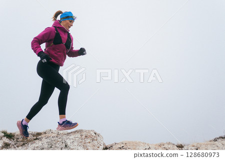Trail Runner in Misty Mountain Landscape 128680973