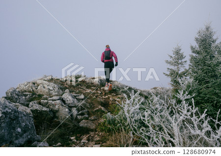 Trail Runner in Misty Mountain Landscape 128680974