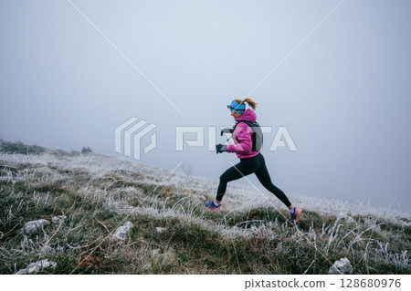 Trail Runner in Misty Mountain Landscape 128680976