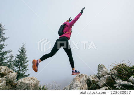 Trail Runner in Misty Mountain Landscape 128680997