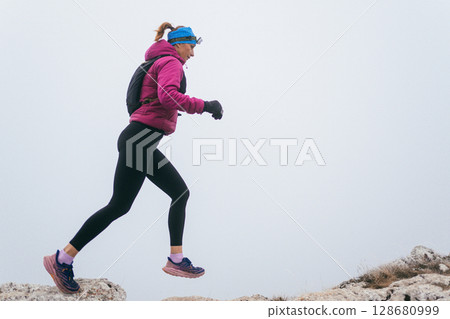 Trail Runner in Misty Mountain Landscape Trail Runner in Misty Mountain Landscape 128680999