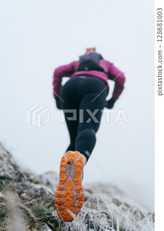 Trail Runner in Misty Mountain Landscape 128681003