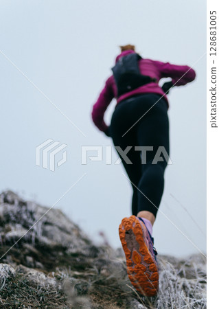 Trail Runner in Misty Mountain Landscape 128681005