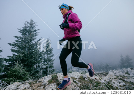 Trail Runner in Misty Mountain Landscape 128681010