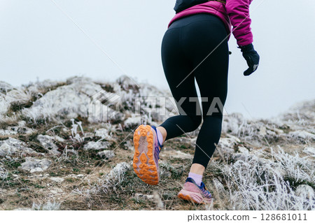 Trail Runner in Misty Mountain Landscape 128681011