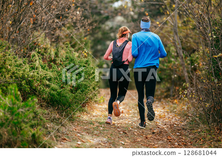 Happy Couple Running on a Forest Trail 128681044