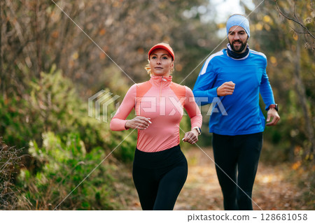 Happy Couple Running on a Forest Trail 128681058