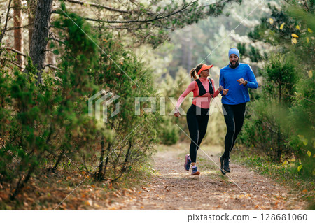 Happy Couple Running on a Forest Trail 128681060
