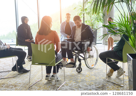 Corporate business team meeting with a manager or coach. Group of happy diverse, multiracial people sitting in a circle 128681150