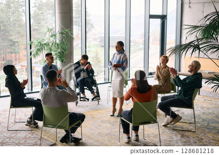 Corporate business team meeting with a manager or coach. Group of happy diverse, multiracial people sitting in a circle Corporate business team meeting with a manager or coach. Group of happy diverse, multiracial people sitting in a circle 128681218