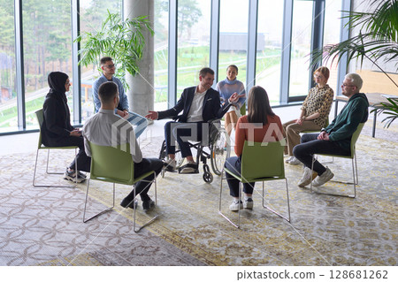 Corporate business team meeting with a manager or coach. Group of happy diverse, multiracial people sitting in a circle Corporate business team meeting with a manager or coach. Group of happy diverse, multiracial people sitting in a circle 128681262
