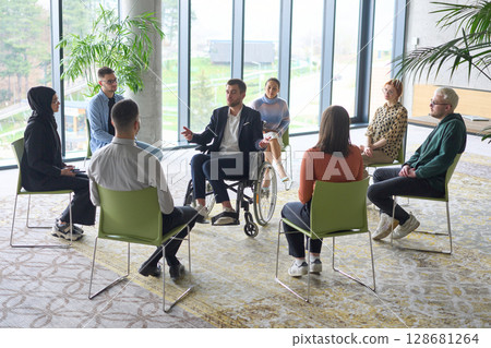 Corporate business team meeting with a manager or coach. Group of happy diverse, multiracial people sitting in a circle  128681264