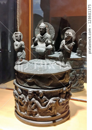 A precious relic vase containing a Shaka Triad on display at the Peshawar Museum in Pakistan, the capital of Gandhara A precious relic vase containing a Shaka Triad on display at the Peshawar Museum in Pakistan, the capital of Gandhara 128681375