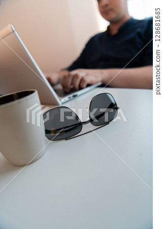 Close-up photo of a programmer typing on a laptop 128681685