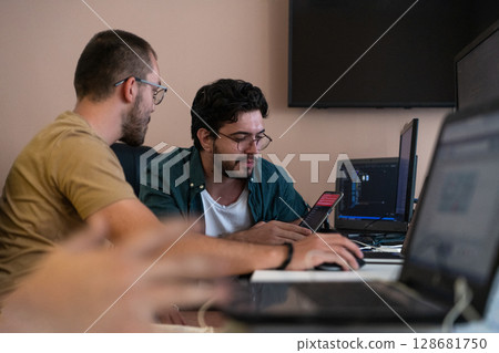 Collaborative Minds: A Team of Programmers Tackling Challenges Together in the Office. 128681750