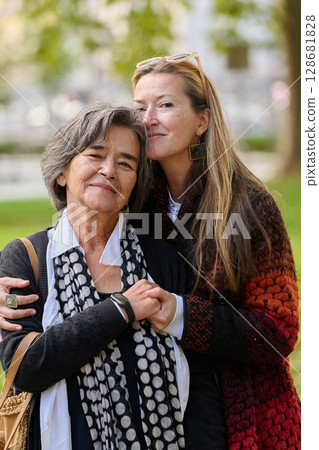 A Heartfelt Embrace: A Daughters Support for Her Mother on a Beautiful Autumn Day. A Heartfelt Embrace: A Daughters Support for Her Mother on a Beautiful Autumn Day. 128681828