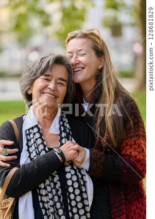 A Heartfelt Embrace: A Daughters Support for Her Mother on a Beautiful Autumn Day. A Heartfelt Embrace: A Daughters Support for Her Mother on a Beautiful Autumn Day. 128681829