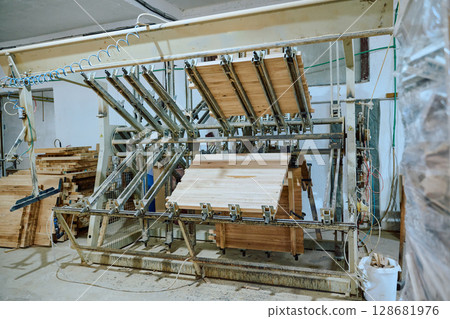 Interior of Wood Processing Industry Featuring CNC Cutting Machines and Wood Processing Equipment 128681976