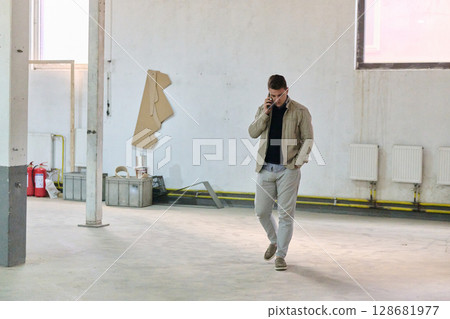 Engineer Using Smartphone in Warehouse of Wood Furniture Production and Processing Company 128681977