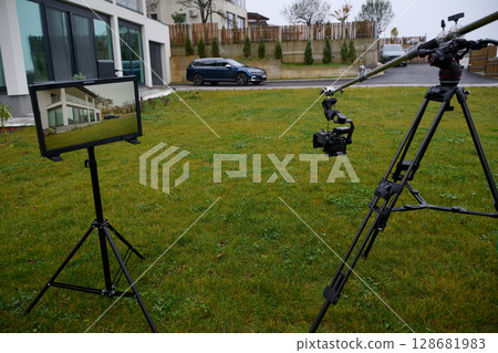 Videography team setting up the professional equipment and cameras for a high-quality music video shoot. Videography team setting up the professional equipment and cameras for a high-quality music video shoot. 128681983