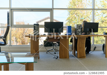 Modern Office Interior with Wooden Furniture, Conference Table, and Computers Modern Office Interior with Wooden Furniture, Conference Table, and Computers 128681995