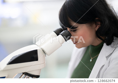 Doctor scientist using microscope in laboratory 128682074