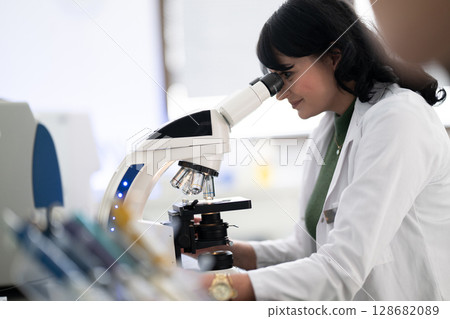 Doctor scientist using microscope in laboratory 128682089