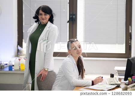 Two female lab technicians working in laboratory 128682093