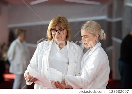 Group of female doctors reviewing medical document 128682097