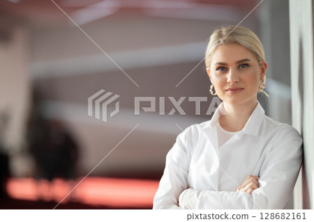 Portrait of confident female doctor in clinic hallway 128682161