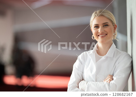 Portrait of confident female doctor in clinic hallway 128682167