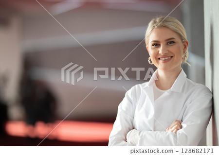 Portrait of confident female doctor in clinic hallway Portrait of confident female doctor in clinic hallway 128682171
