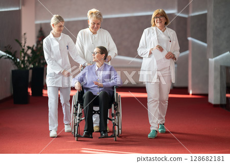 Doctor checking patients progress in wheelchair 128682181