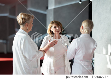 Group of medical professionals having discussion Group of medical professionals having discussion 128682216