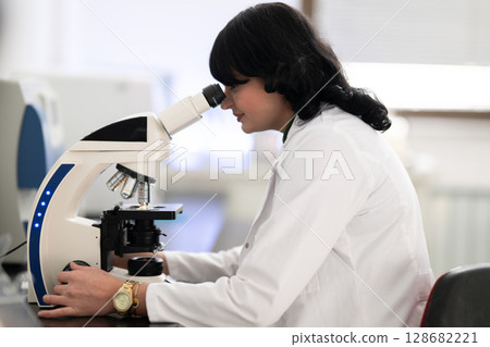 Doctor scientist using microscope in laboratory Doctor scientist using microscope in laboratory 128682221