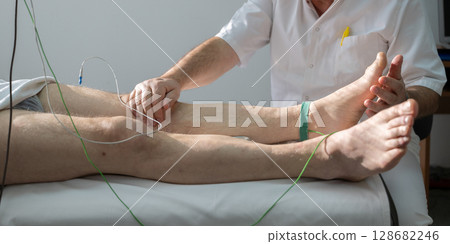 Doctors performing patient diagnostics with equipment 128682246