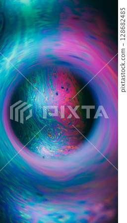 Shiny defocused portal. Ink spill. Color fluid mix glowing sphere. Purple blue green gasoline fluorescent abstract frame black background. 128682485