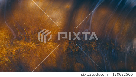 Sparkling paint. Golden fluid. Defocused golden yellow blue color liquid flow splash bright texture floating on abstract background. 128682500