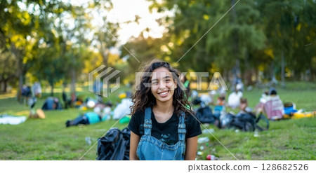 Smiling Young Volunteer Cleaning Up Trash in a Park.Generated image 128682526