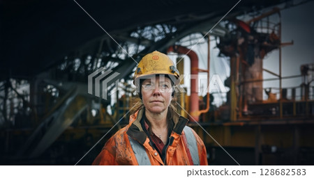 Woman in Protective Gear and Helmet Working on Oilfield Construction Site.Generated image 128682583