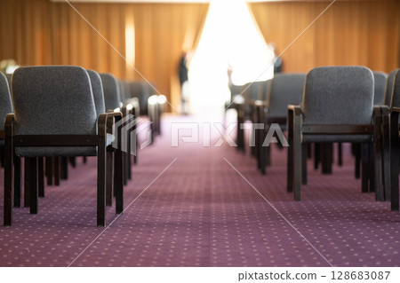 Empty Conference Hall with Rows of Chairs 128683087