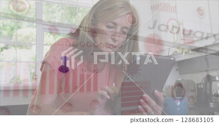 Mature woman analyzing data overlays on tablet in kitchen area, with stylus and coffee mug Mature woman analyzing data overlays on tablet in kitchen area, with stylus and coffee mug 128683105