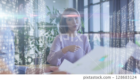 Image of diverse business people talking over data processing 128683124