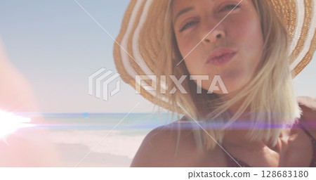 Image of light over happy caucasian woman sending kisses Image of light over happy caucasian woman sending kisses 128683180
